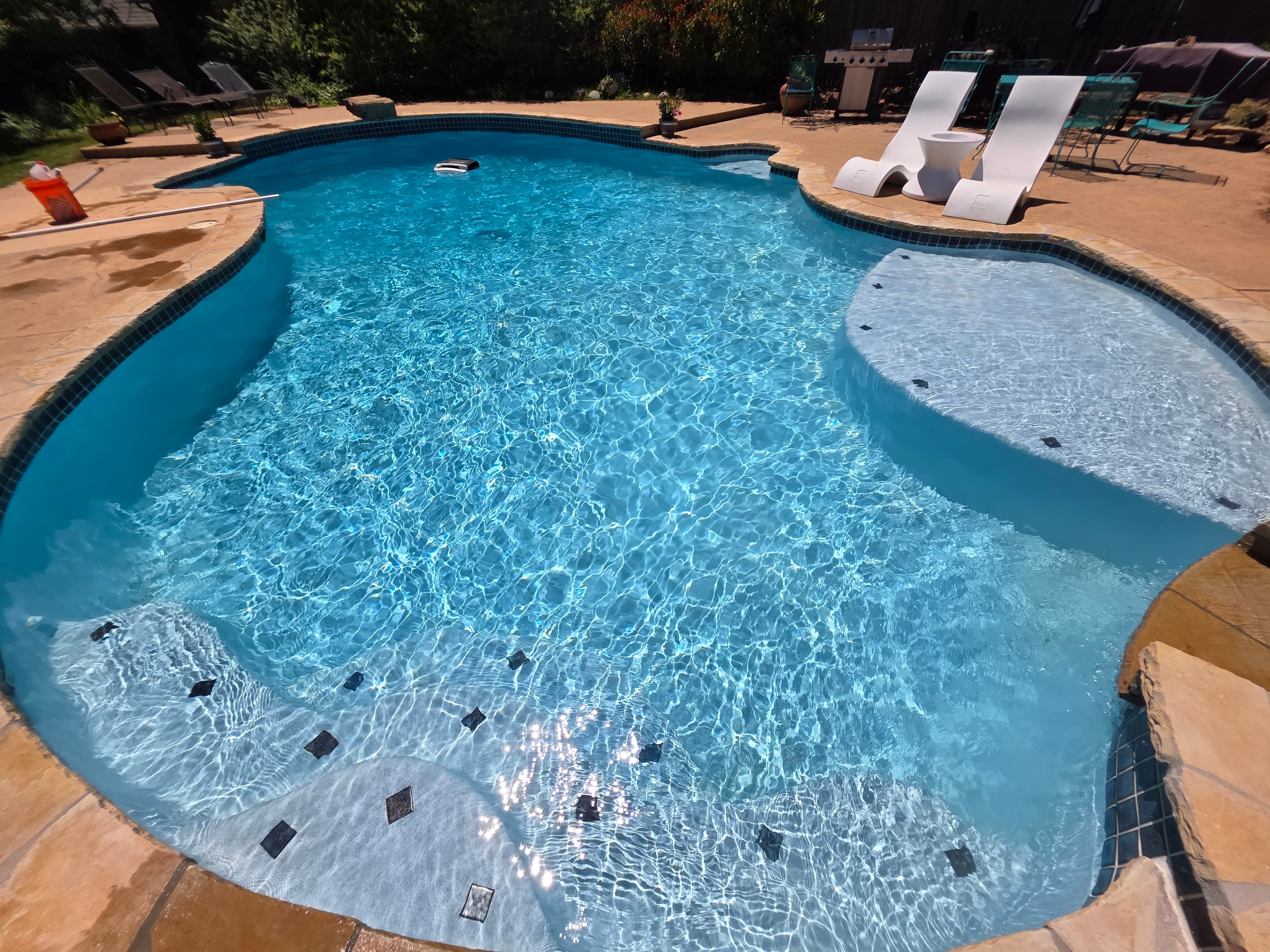 Beautiful newly plastered pool with spa and slide — startup technician service